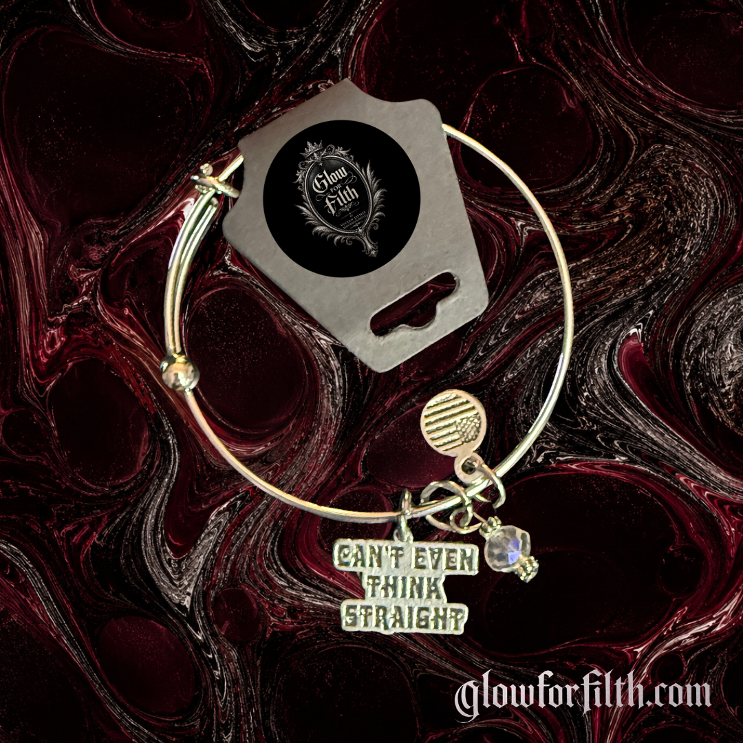 Silver-tone expandable bangle bracelet featuring a "Can't Even Think Straight" charm, crystal accent bead, and decorative charms displayed on a dark gothic background.