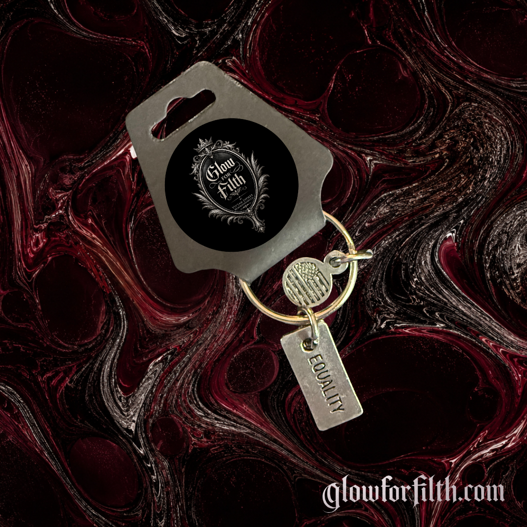 Silver-tone keychain featuring a lead-free pewter Equality charm displayed on a gothic burgundy and black marbled background.