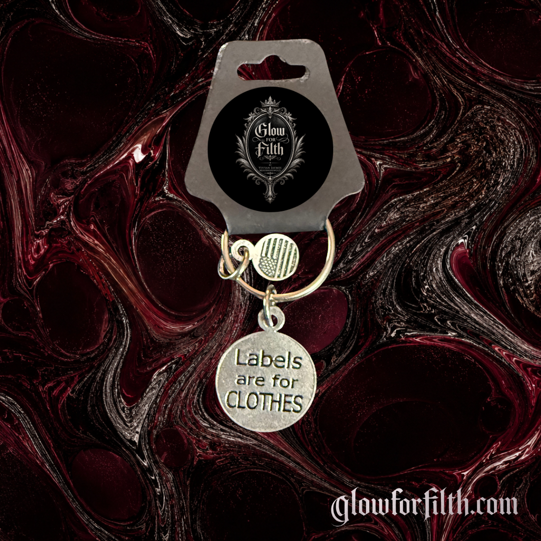 Silver-tone keychain featuring a lead-free pewter Labels Are for Clothes charm displayed on a burgundy and black gothic background.