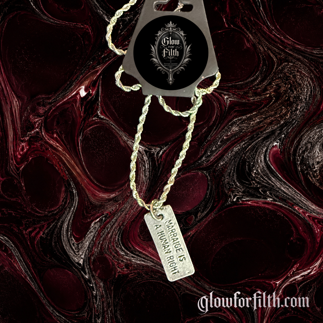 Silver-tone rope chain necklace featuring a lead-free pewter Marriage Is a Human Right pendant displayed on a gothic burgundy and black marbled background.