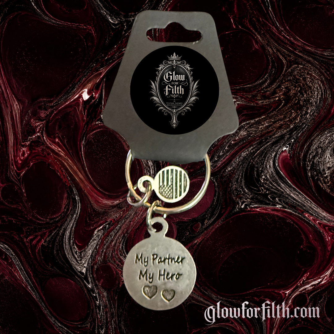 Silver-tone keychain featuring a lead-free pewter My Partner My Hero charm displayed on a gothic burgundy and black marbled background.